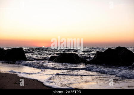 Bel tramonto (sunrise) sul mare, onde bellissime. Messa a fuoco selettiva. Foto Stock