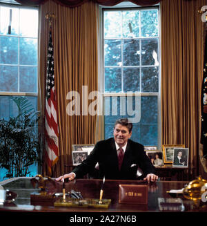 Il Presidente Ronald Reagan alla sua scrivania in ufficio ovale, Washington, D.C. Foto Stock