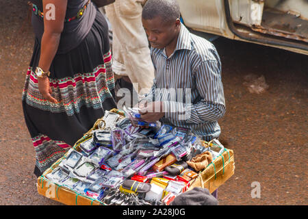 KAMPALA, Uganda - Ottobre 03, 2012. Un uomo vende telefono cellulare casi presso il parcheggio taxi a Kampala in Uganda su ottobre 03,2012. Foto Stock