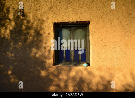 Luci e ombre sulla finestra marocchino in adobe tradizionale casa. Il Marocco Foto Stock