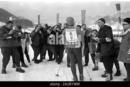 Uno dei partecipanti è circondato da premere i fotografi e giornalisti dopo il suo arrivo al traguardo della gara di Hahnenkamm. La gara di Hahnenkamm ha tenuto il monte Hahnenkamm in Kitzbuehel dal 1931. Foto Stock