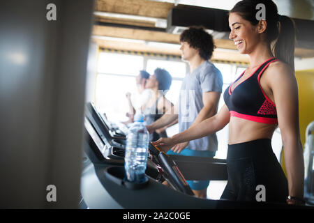 Montare belle persone che esercitano insieme in palestra Foto Stock