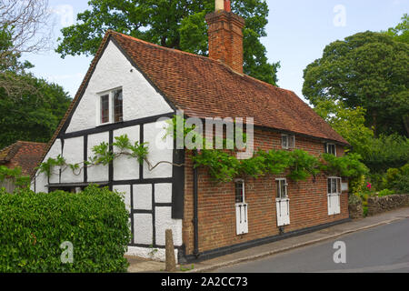 Guildford, Inghilterra - Agosto 2, 2019: imbiancate a calce e mattoni e piastrelle Cottage a Shere nel Surrey. Foto Stock