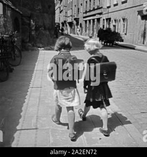 Zwei Schulmädchen auf dem Weg Nach Hause in Regensburg, Deutschland 1930er Jahre. Due ragazze della scuola sulla loro strada di casa a Regensburg, Germania 1930s. Foto Stock
