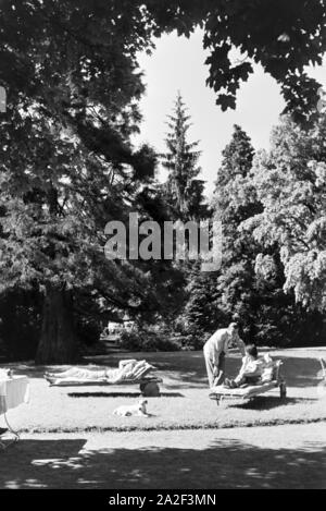 Reisende entspannen im Garten des Hotels Wehrle a Triberg im Schwarzwald, Deutschland 1930er Jahre. Gli ospiti dell'Hotel relax nel giardino del hotel Wehrle in Triberg nella Foresta Nera, Germania 1930s. Foto Stock