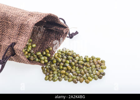 Mung bean e sacco di iuta isolati su sfondo bianco Foto Stock