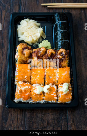 Set di sushi in contenitore di plastica Box / pacchetto. California Roll, New York rotolo, il rullo del braccio, zenzero, wasabi e salsa di soia. I cibi tradizionali. Foto Stock