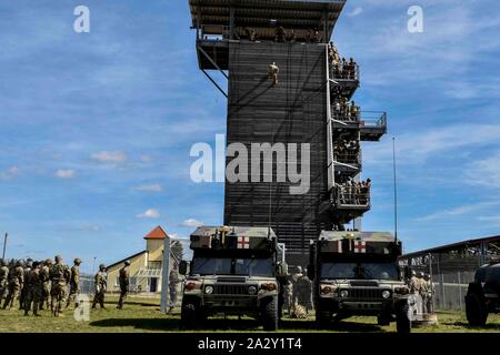 Un soldato rappels lungo la torre verso il basso durante l'Air Assault Course, Camp Aachen, Germania, Settembre, 17, 2019. La Air Assault Course è progettato per preparare i soldati per le missioni che richiedono l'uso di mezzi di trasporto multiuso e elicotteri d'assalto. Foto Stock