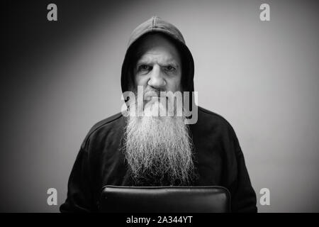 Ritratto di grave coppia calvo uomo barbuto che indossa felpa con cappuccio in bianco e nero Foto Stock