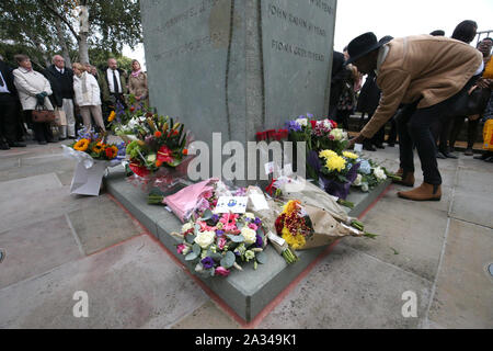 Amici e parenti nel memorial garden si affaccia la linea ferroviaria a Ladbroke Grove nel ventesimo anniversario dell'incidente ferroviario alla stazione Paddington dove un totale di 31 persone morirono quando due treni si sono scontrate quasi testa-a. Foto Stock