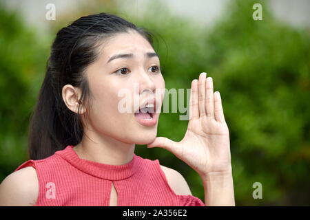 Un giovane bambino asiatico parlando Foto Stock