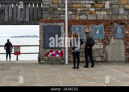 Un giovane che guarda alla guerra delle Falkland memorial presso hotwalls in old Portsmouth un monumento commemorativo dedicato alla Royal Navy navi affondate durante la guerra delle Falkland Foto Stock