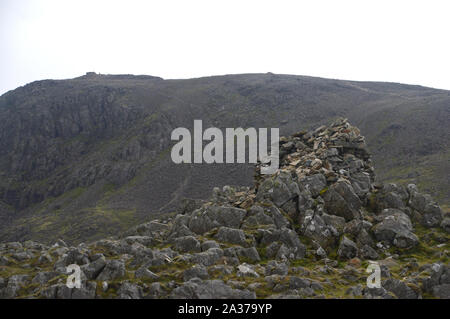 Il più alto Wainwright Scafell Pike dal mucchio di pietre sul Vertice di Lingmell nel Parco Nazionale del Distretto dei Laghi, Cumbria, Regno Unito, Foto Stock