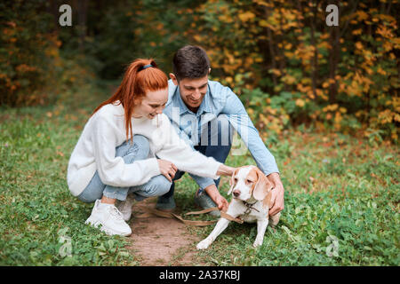 Giovani godersi il tempo con il loro adorabile cane preferito a piena lunghezza foto. positiva sensazione ed emozione Foto Stock