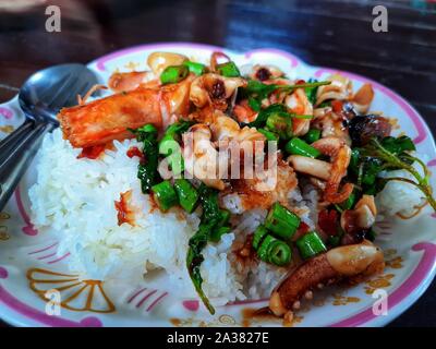 Il riso condito con stir-pesce fritto e basilico Foto Stock