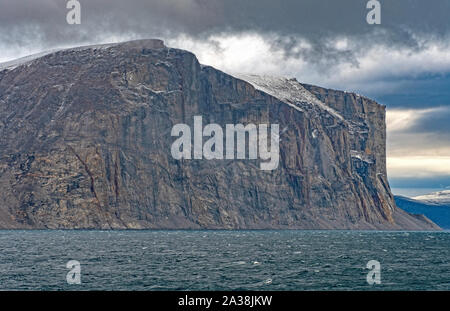 Scogliere a picco sul mare in un giorno nuvoloso in Sam Ford Fjord sull Isola Baffin in Nunavut, Canada Foto Stock