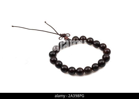 A close up image of dark wood bead bracelets isoalted on a white background Foto Stock
