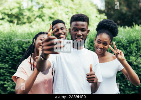 Gruppo di studenti prendendo l autoritratto con la fotocamera del telefono Foto Stock