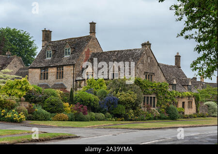 Cottage con il tetto di paglia con piante rampicanti nel villaggio di Broadway, nella contea inglese del Worcestershire, Cotswolds, REGNO UNITO Foto Stock