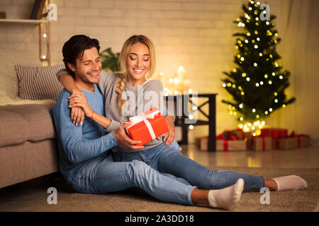 Presenta il tempo. L uomo dando nuovo anno presente alla moglie Foto Stock