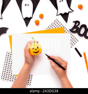 Disegno donna faccia sorridente sul Halloween zucca di carta Foto Stock