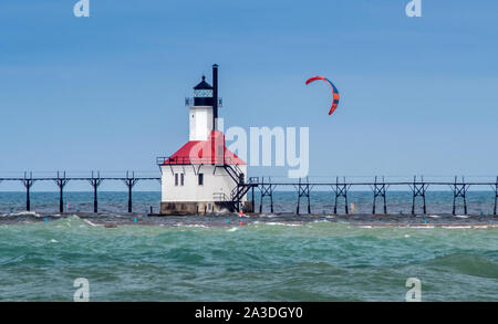 St Joe Michigan, Stati Uniti d'America , 14 settembre 2019; un colorato aquilone vola parte il San Giuseppe casa di luce nel Michigan STATI UNITI D'AMERICA, con un attivo kite boarder appesi Foto Stock