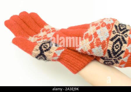 Le mani della donna mettendo su guanti di lana. Sfondo bianco Foto Stock