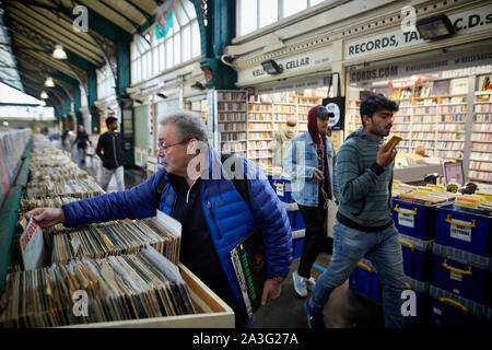 Cardiff Galles, all'interno del vecchio mercato centrale off High Street uomo acquisto di dischi in vinile in corrispondenza di una seconda mano in stallo Foto Stock