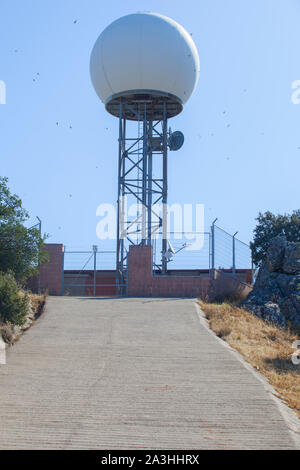 Radar meteorologico stazione sulla parte superiore della Sierra de Fuentes, Spagna, area spa. Rondini battenti intorno oltre il cielo blu Foto Stock