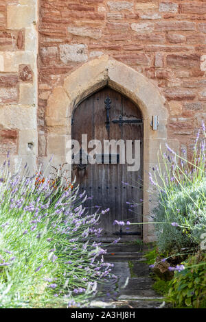 Porta anteriore ad arco in legno di una casa in Vicars Close, Wells, Somerset, Inghilterra Foto Stock