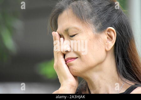 Un triste senior persona asiatica Foto Stock