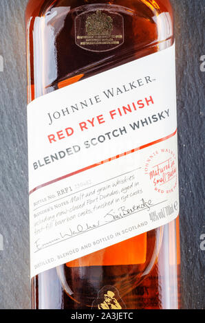 Johnnie Walker Red finitura rye whisky mescolato su pietra ardesia sfondo. Johnnie Walker è stato istituito nel 1820 a Kilmarnock, in Scozia Foto Stock