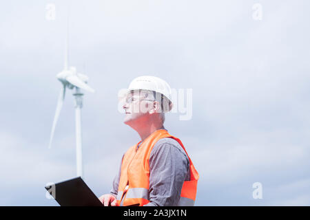 I vecchi ingegnere energetico nella parte anteriore di un mulino a vento Foto Stock