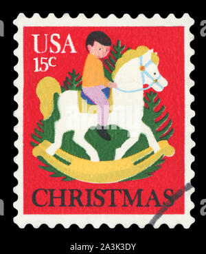 Stati Uniti - circa settanta: un timbro postale stampato negli USA mostra un bambino sul cavallo Hobby, è stato rilasciato da USPS per celebrare il Natale. circa settanta Foto Stock