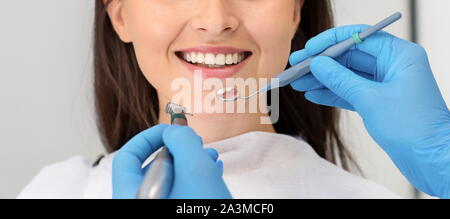 Immagine ritagliata della donna sorridente attenting clinica dentale Foto Stock