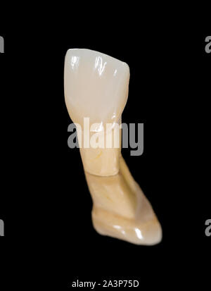 Ceramica dentale corona isolata su sfondo nero Foto Stock