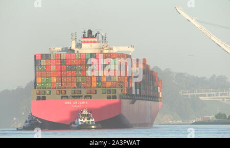 Oakland, CA - Aprile 24, 2019: più rimorchiatori assistere nave cargo uno ARCADIA manuever nel porto di Oakland, il quinto porto più trafficato nel Regno Foto Stock