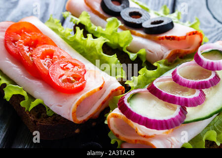 Panini con pomodori Tritare le olive e la cipolla rossa Foto Stock