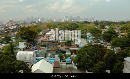 La città di Manila, la capitale delle Filippine e di Manila Nord cimitero, vista dall'alto. Edifici moderni nel centro della citta'. Foto Stock