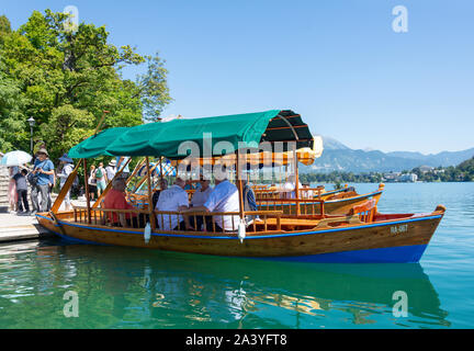 In legno tradizionali Pletna barche ormeggiate sulla isola di Bled, lago di Bled Bled, Alta Carniola Regione, Slovenia Foto Stock