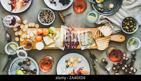 Picnic stagionale con vino rosato, formaggio, salumi, frutta a guscio e frutta Foto Stock