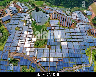 Array di pannelli solari sono installati presso le terre incolte su una collina nel villaggio Huangsha, Zhuangkou town, Huichang county, Ganzhou città, Oriente Cina Foto Stock