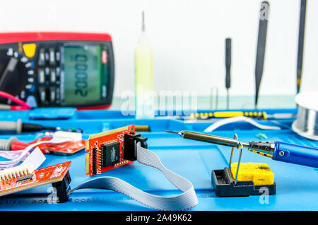 L'elettricista sul posto di lavoro. Elettronica. Regimi di ferro di saldatura. multimetro Foto Stock