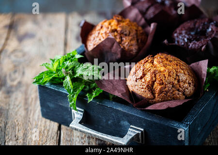 In casa freschi di forno muffin alla carota con granella di nocciole e arancione su sfondo di legno Foto Stock