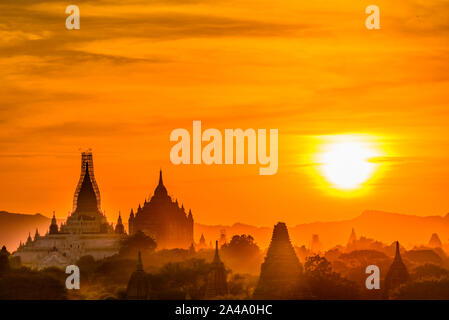 Golden sunrise su Bagan, Myanmar. foggy sky con silhouette dalla storica templi buddisti e gli stupa. La Birmania. Foto Stock