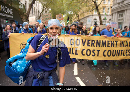 110 XR medici hanno marciato da South Bank a Trafalgar Square (polizia ha detto che avrebbero dovuto essere arrestato se essi sono andati a Piazza del Parlamento come per il piano originale) per protestare contro l'inerzia sulla crisi climatica ...dove essi simbolicamente tolse i pattini e indossavano delle maschere per rappresentare le 110 persone al giorno che muoiono prematuramente a causa di inquinamento atmosferico a Londra la ribellione di estinzione protesta ha continuato a Londra dal 7 ottobre. Lo scopo della partecipazione di massa in non-violenta azione diretta e di disobbedienza civile è stato quello di richiamare l attenzione sulla crisi del clima e la perdita di biodiversità. La Ribellione di estinzione richiede un Foto Stock