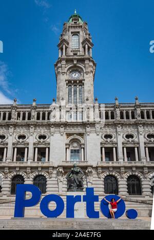 Donna di mezza età con Porto segno davanti al palazzo del municipio. Foto Stock