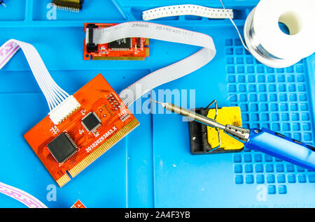 L'elettricista sul posto di lavoro. Elettronica. Regimi di ferro di saldatura Foto Stock