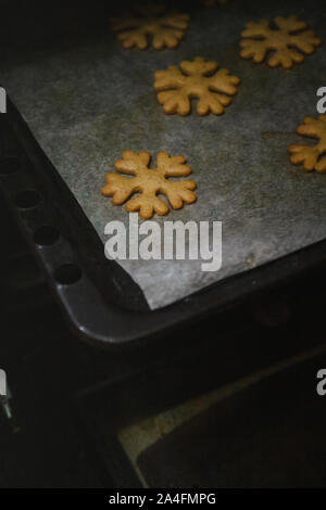 Per ottenere gingerbread cookie sotto forma di fiocchi di neve da una presina. Foto Stock