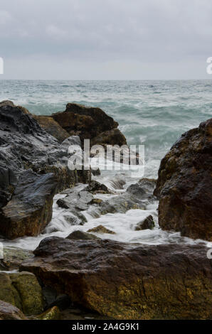 Acqua di mare scorre tra le rocce della costa nel Parco Nazionale Tayrona, Colombia Foto Stock